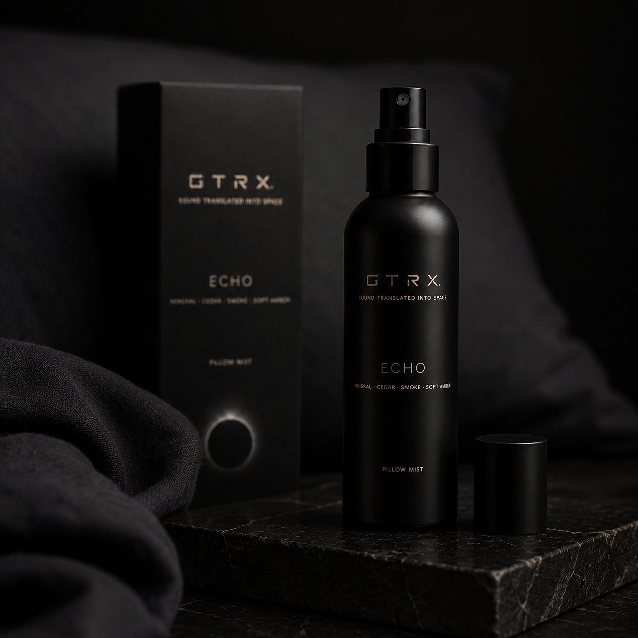 GTRX Echo pillow mist bottle resting on dark fabric